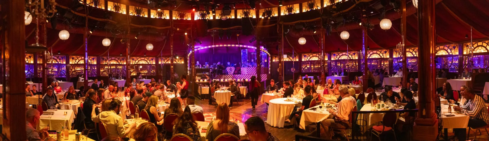 Tables and stage inside the Kermess tent